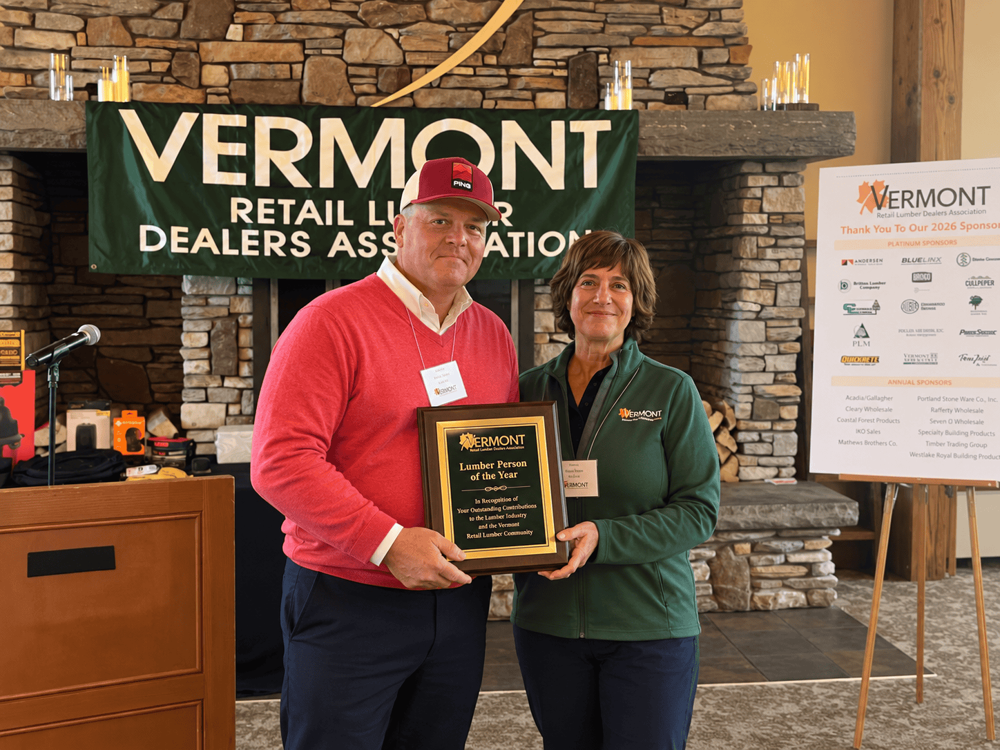 Jeremy Baker accepts the 2026 Lumberperson of the Year award from current VRLDA President Claudia Homan